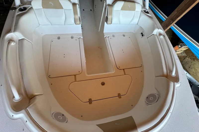 Slide: The Image of 2017 Edgewater 248CX Crossover boat interior with seating and storage compartments. - 17