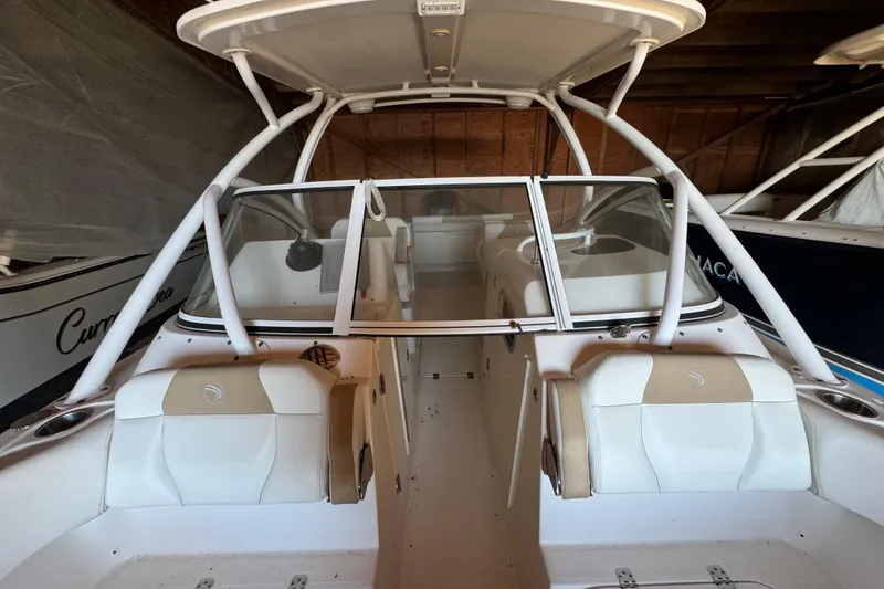 Slide: The Image of 2017 Edgewater 248CX Crossover boat interior with white seating and windshield. - 18