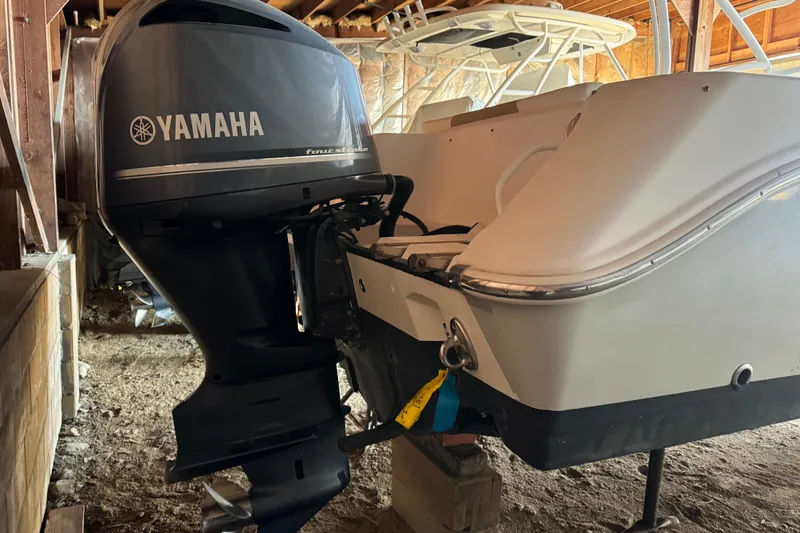 Slide: The Image of 2017 Edgewater 248CX Crossover with Yamaha outboard engine in storage. - 5