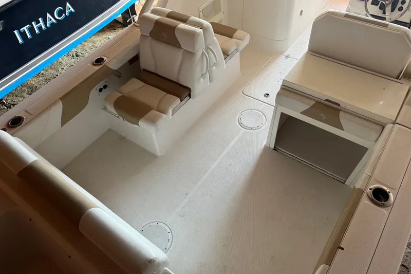 Slide: The Image of 2017 Edgewater 248CX Crossover boat interior with seating and storage. - 8