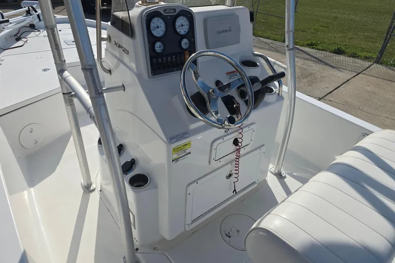 Slide: The Image of 2013 Sea Hunt XP 21 boat console with steering wheel and Garmin display. - 10