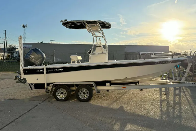 Slide: The Image of 2013 Sea Hunt XP 21 boat on trailer at sunset, featuring Yamaha engine. - 4