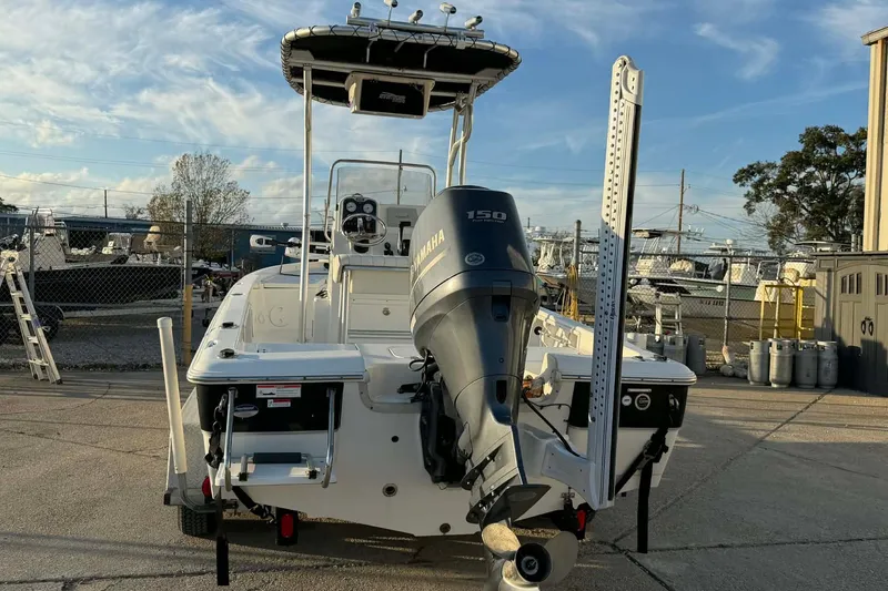 Slide: The Image of 2013 Sea Hunt XP 21 boat with Yamaha 150 engine, docked in a marina. - 5