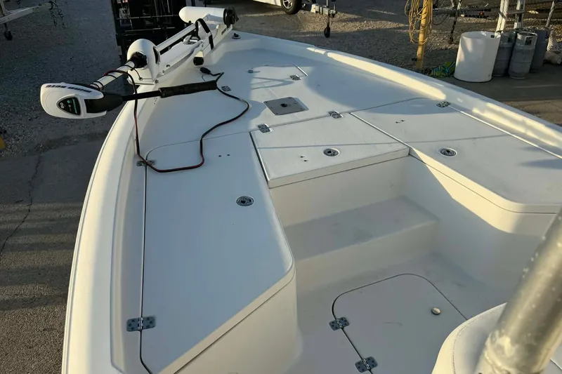 Slide: The Image of 2013 Sea Hunt XP 21 boat deck with mounted equipment, in a marina setting. - 6