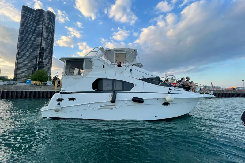 Slide: The Image of 2006 Silverton 35 Motor Yacht docked with city skyline in background. - 14