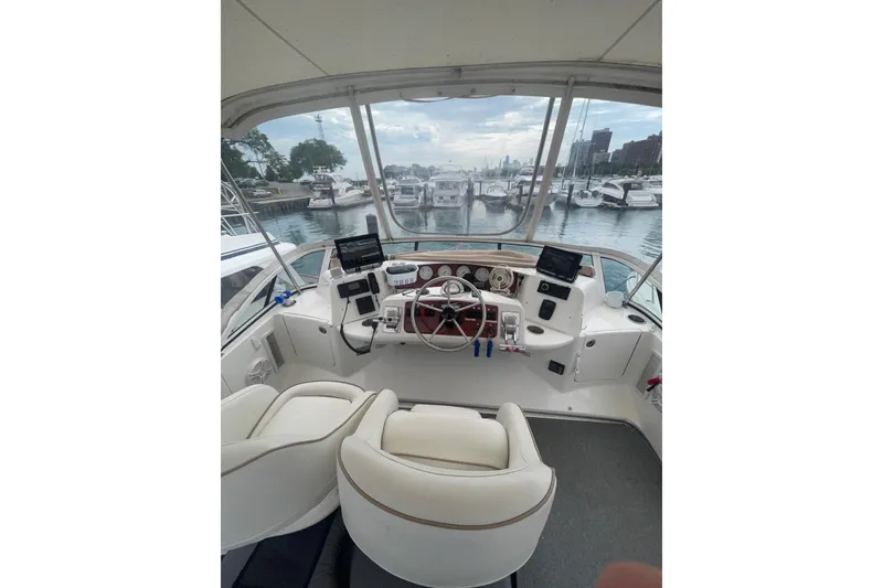 Slide: The Image of 2006 Silverton 35 Motor Yacht docked at marina under cloudy sky. - 17
