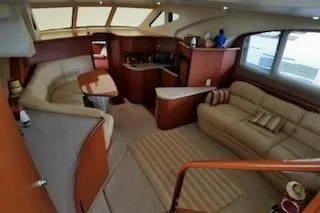 Slide: The Image of Cozy bedroom interior of 2006 Silverton 35 Motor Yacht with plush bedding and porthole windows. - 20