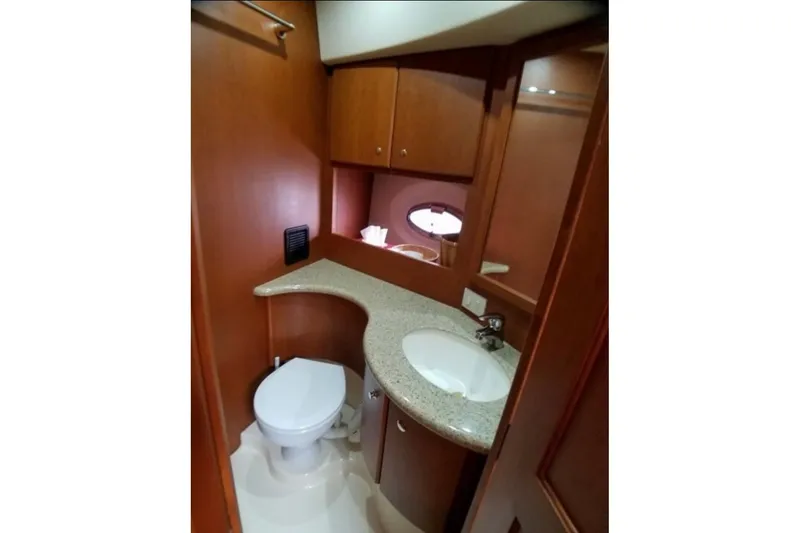 Slide: The Image of Interior of 2006 Silverton 35 Motor Yacht with cozy seating and wooden cabinetry. - 21