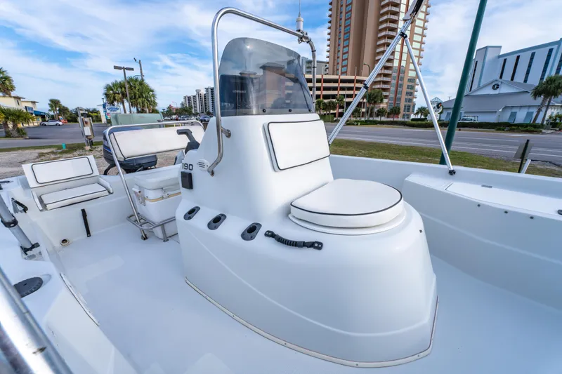 Slide: The Image of 2002 ProMaster 190 BAY boat interior with steering console and cityscape background. - 18