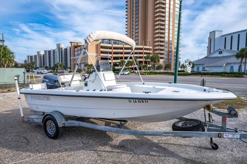 Slide: The Image of 2002 ProMaster 190 BAY boat on trailer, urban background, clear sky. - 3