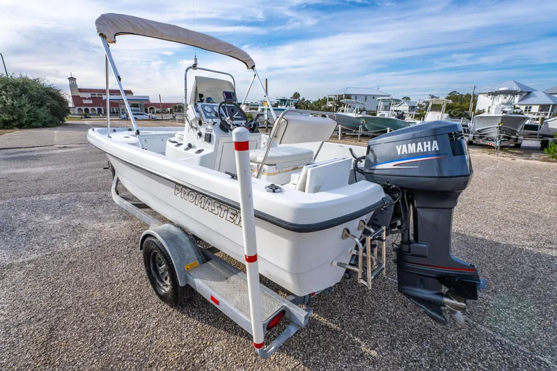 Slide: The Image of 2002 ProMaster 190 BAY boat with V4 115 engine, parked on a trailer. - 7