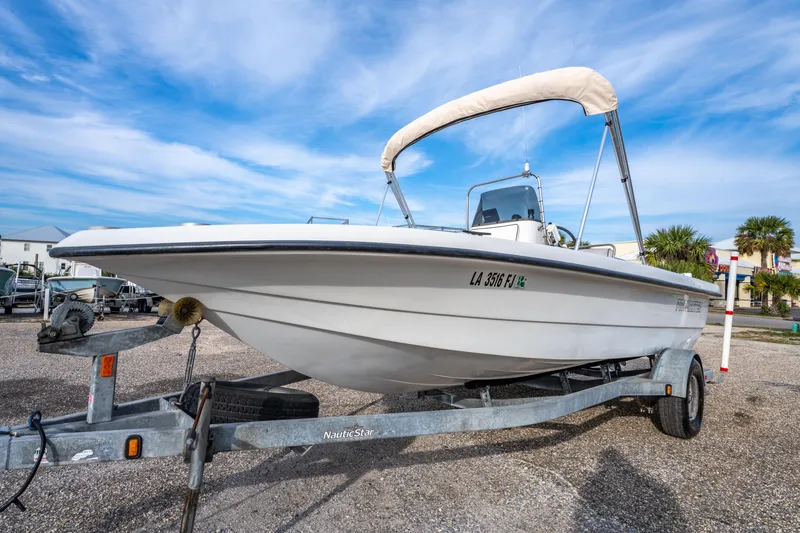 Slide: The Image of 2002 ProMaster 190 BAY boat on trailer in marina setting under blue sky. - 9