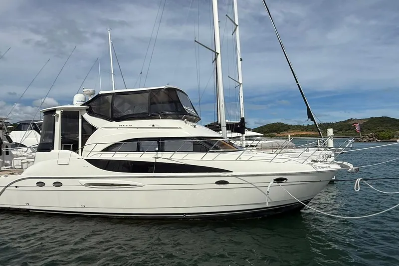 The Image of 2004 Meridian 459 Motoryacht docked in a marina, side view. - 1