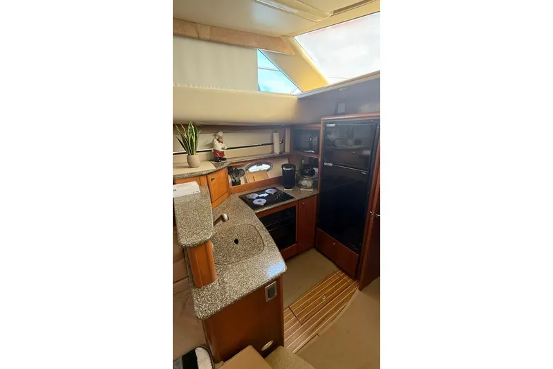 Slide: The Image of 2004 Meridian 459 Motoryacht kitchen with granite countertops and modern appliances. - 10