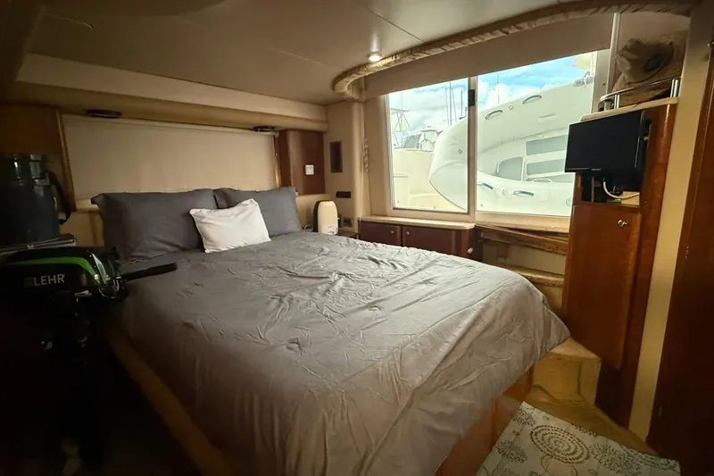 Slide: The Image of Luxurious bedroom interior of 2004 Meridian 459 Motoryacht with large window and cozy bedding. - 16