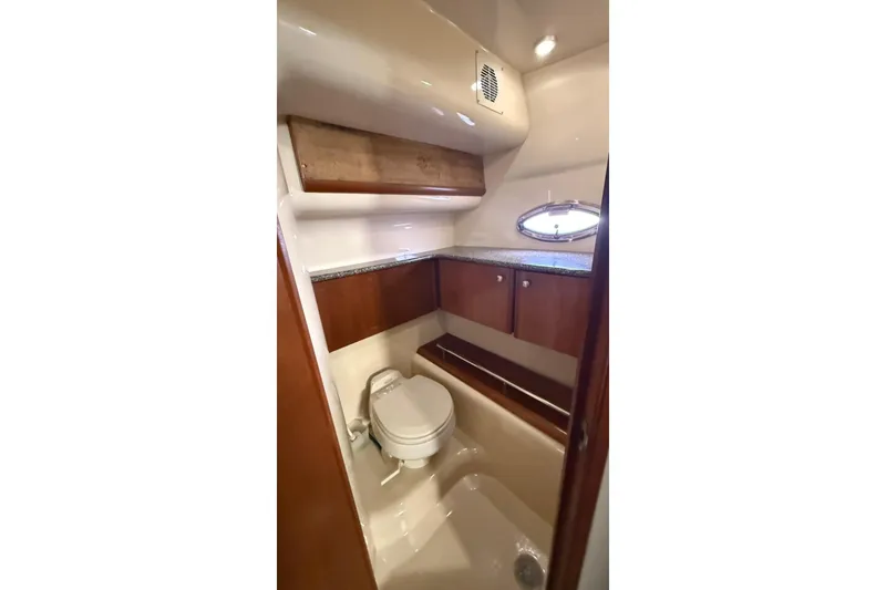 Slide: The Image of Luxurious bathroom in 2004 Meridian 459 Motoryacht with wood cabinetry and porthole window. - 18