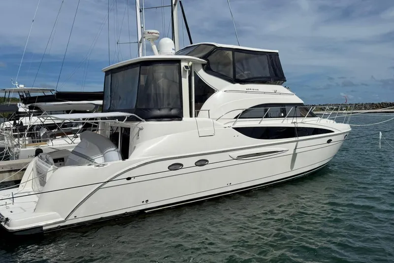 Slide: The Image of 2004 Meridian 459 Motoryacht docked in marina, clear sky, calm water. - 3