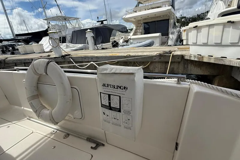 Slide: The Image of 2004 Meridian 459 Motoryacht docked, featuring lifesaving equipment and a lifebuoy on deck. - 5