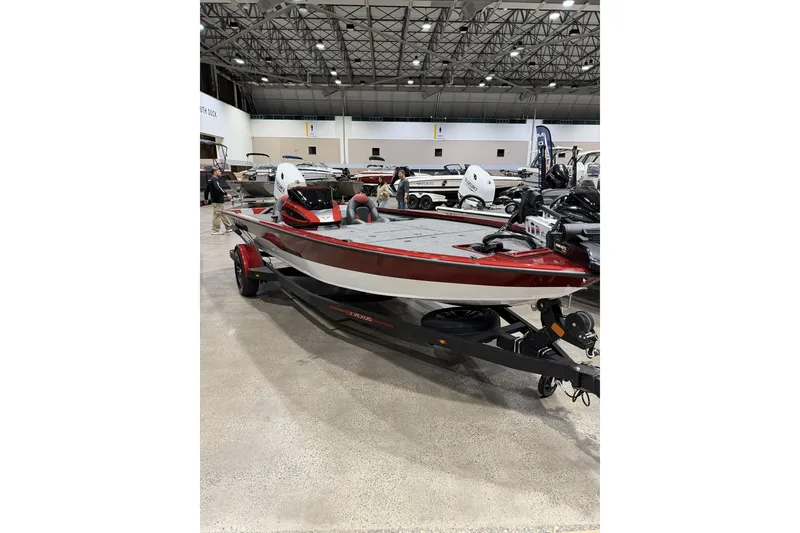 Slide: The Image of 2026 Vexus AVX 1880c boat on display in an indoor showroom. - 2