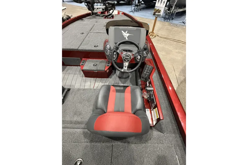 Slide: The Image of 2026 Vexus AVX 1880c boat interior with red and black seating and steering console. - 7