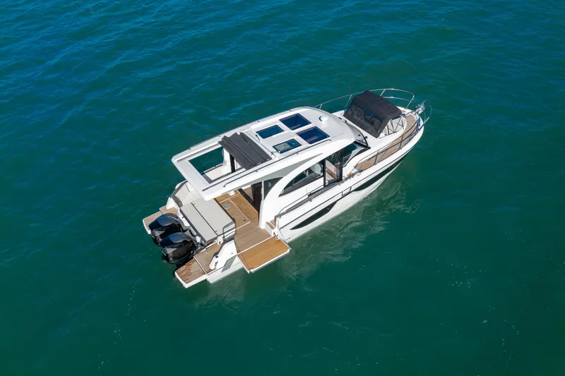 The Image of 2026 Beneteau Antares 11 Coupe cruising on open water under clear blue skies. - 0