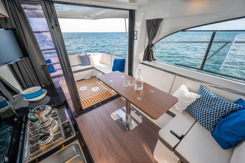 Slide: The Image of Interior of 2026 Beneteau Antares 11 Coupe yacht with ocean view and elegant seating. - 12