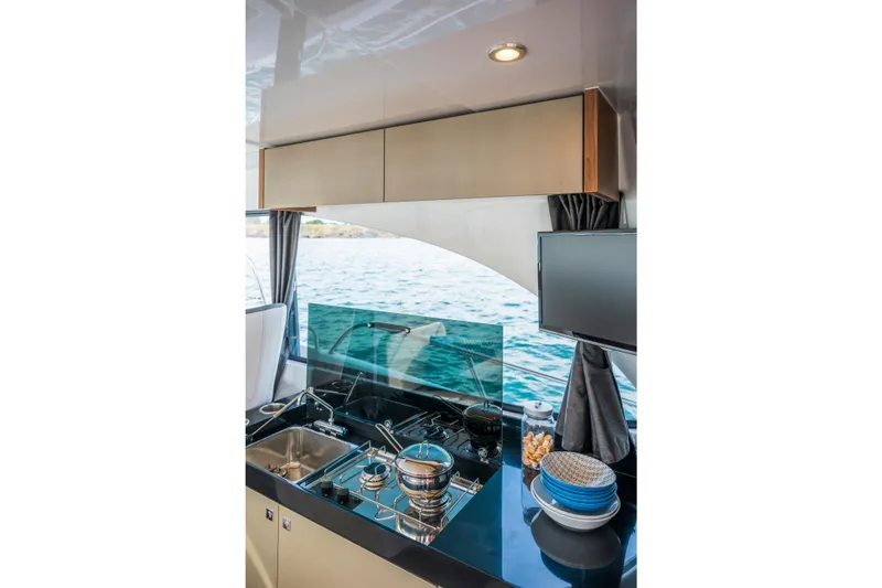 Slide: The Image of Modern kitchen interior of 2026 Beneteau Antares 11 Coupe yacht with ocean view. - 13