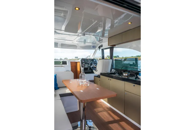 Slide: The Image of Interior of 2026 Beneteau Antares 11 Coupe, featuring modern kitchen and dining area. - 9