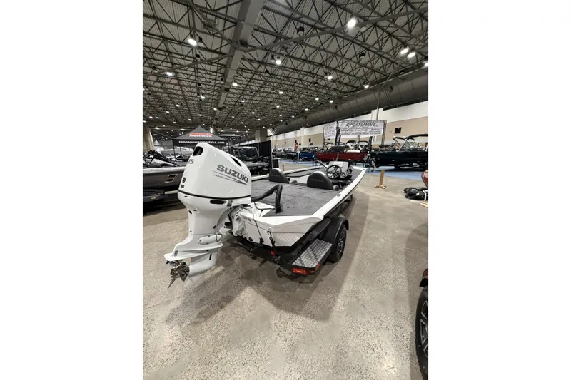 Slide: The Image of 2026 Vexus Defender 189 boat with Suzuki engine displayed indoors. - 3