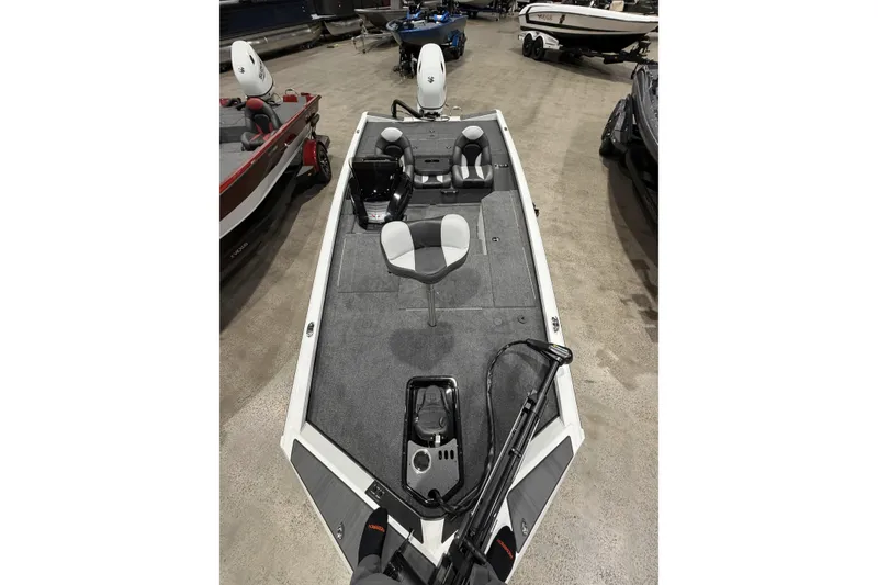 Slide: The Image of 2026 Vexus Defender 189 boat interior with seating and equipment, displayed indoors. - 6