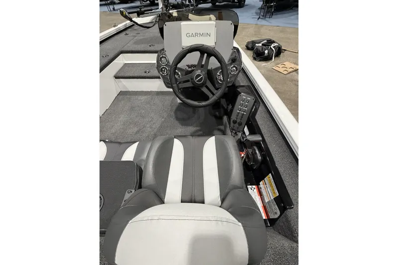 Slide: The Image of 2026 Vexus Defender 189 boat interior with Garmin navigation system and steering wheel. - 9