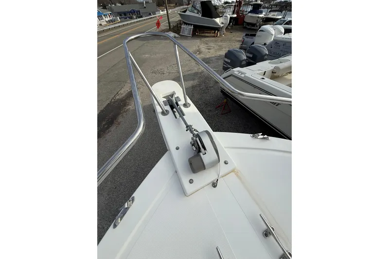 Slide: The Image of 2007 Steiger Craft 26 Miami boat bow with anchor and railing, docked near other boats. - 10