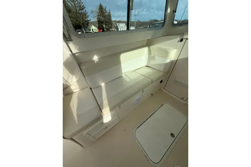 Slide: The Image of 2007 Steiger Craft 26 Miami boat interior with cushioned seating and storage compartments. - 13
