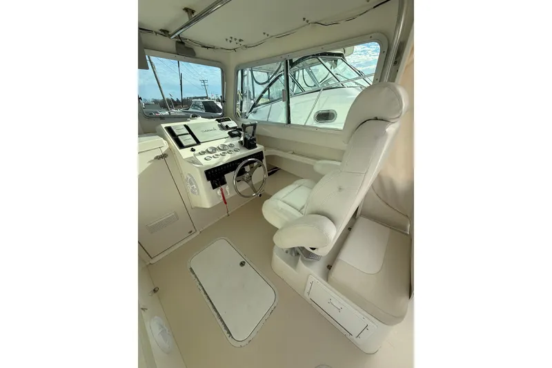 Slide: The Image of 2007 Steiger Craft 26 Miami boat interior with captain's chair and control panel. - 14