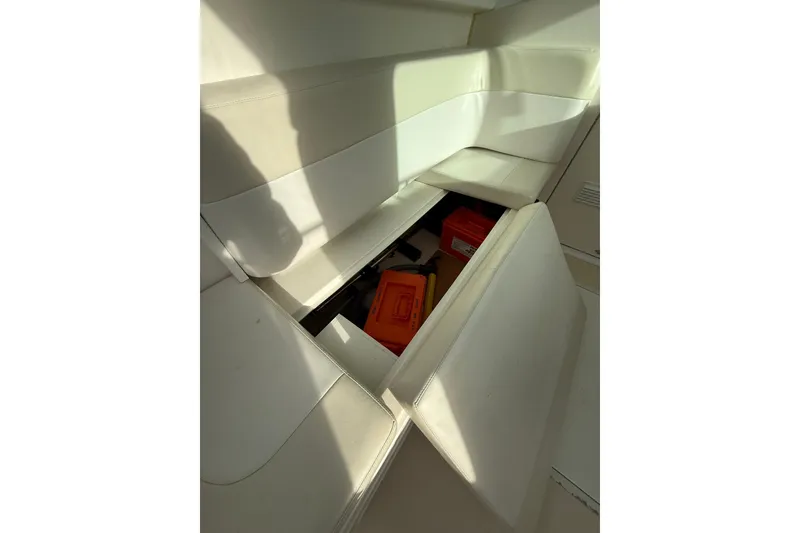 Slide: The Image of Storage compartment in 2007 Steiger Craft 26 Miami boat with white seating. - 16