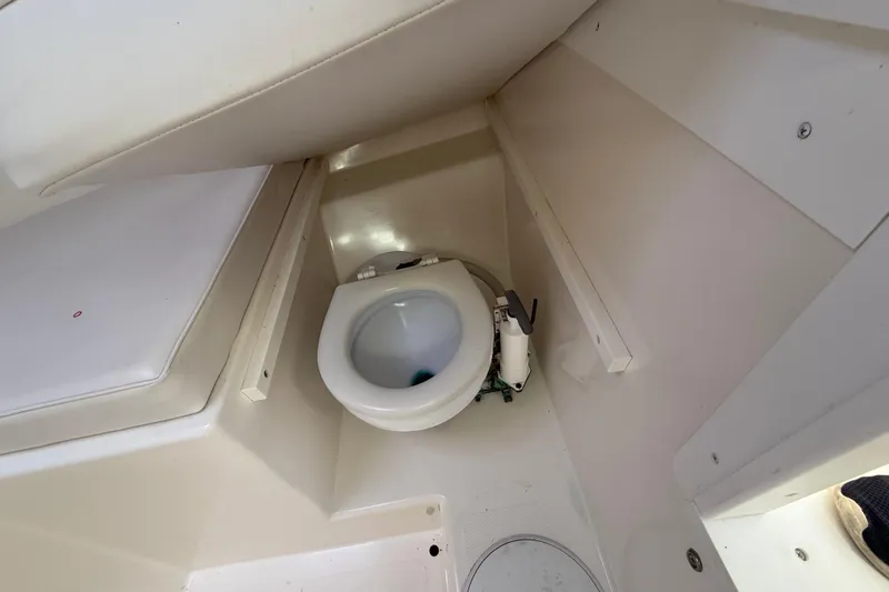 Slide: The Image of 2007 Steiger Craft 26 Miami boat interior with compact marine toilet. - 20