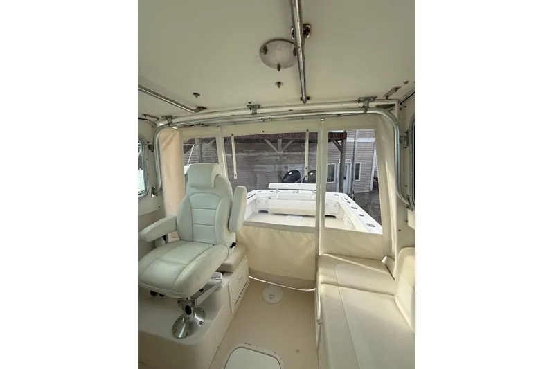Slide: The Image of Interior of 2007 Steiger Craft 26 Miami boat with white seating and helm chair. - 22