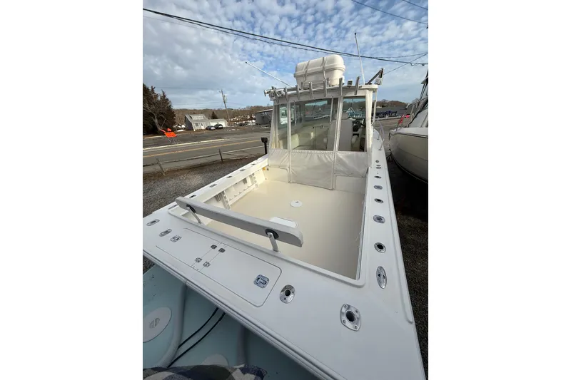 Slide: The Image of 2007 Steiger Craft 26 Miami boat with spacious deck and cabin, docked outdoors. - 3