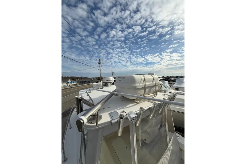 Slide: The Image of 2007 Steiger Craft 26 Miami boat with clear sky and marina background. - 8