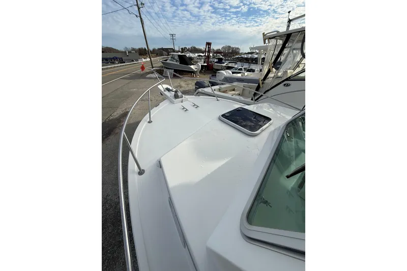 Slide: The Image of 2007 Steiger Craft 26 Miami boat deck with railing, docked near other boats. - 9