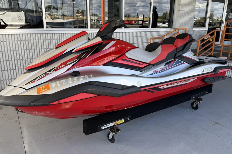 The Image of 2020 Yamaha WaveRunner FX Cruiser SVHO in red and white, parked outside a building. - 0