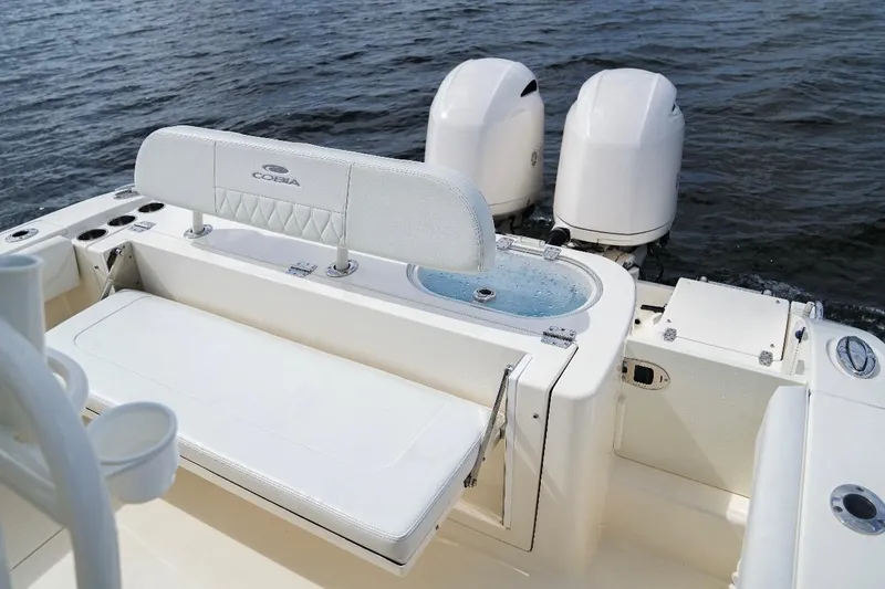 Slide: The Image of 2020 Cobia 262 Center Console boat with dual engines on water. - 10