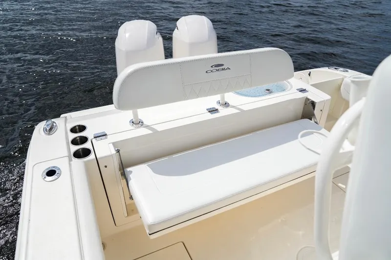 Slide: The Image of 2020 Cobia 262 Center Console boat with seating and cup holders on open water. - 11