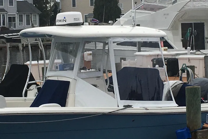 Slide: The Image of 2020 Cobia 262 Center Console boat docked, featuring Garmin radar equipment. - 13