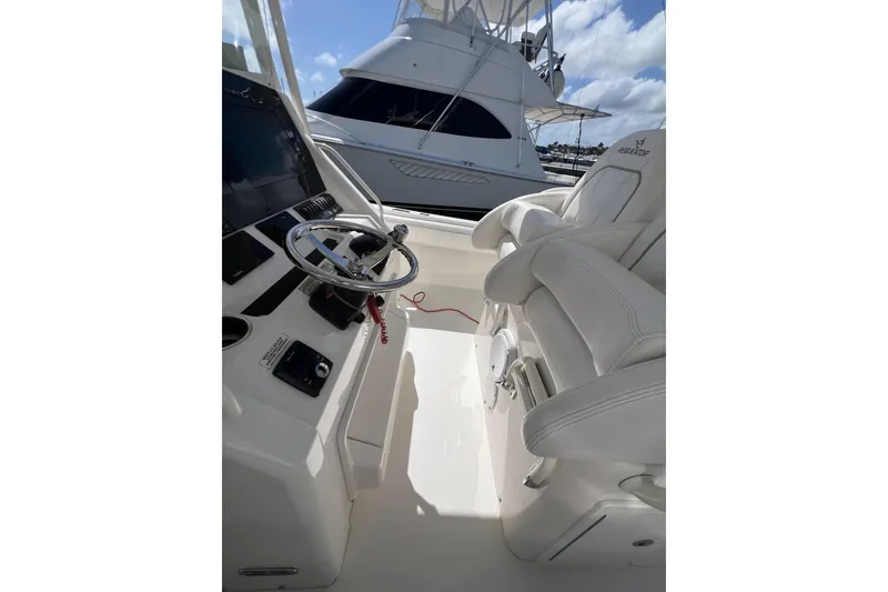Slide: The Image of 2016 Regulator 34 Center Console boat interior with steering wheel and seating. - 15