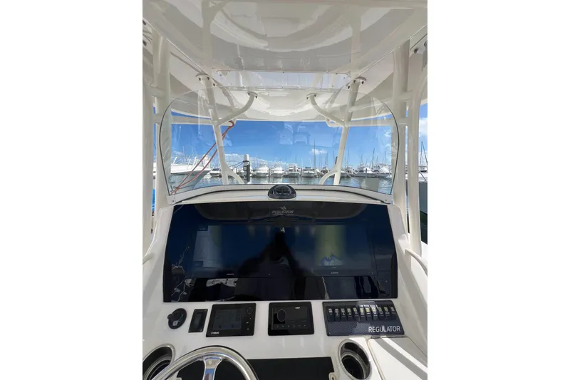 Slide: The Image of 2016 Regulator 34 Center Console boat dashboard with marina view. - 16