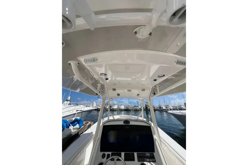 Slide: The Image of 2016 Regulator 34 Center Console boat interior with helm, docked at marina. - 18