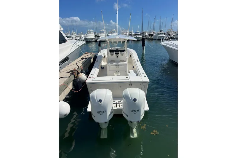 Slide: The Image of 2016 Regulator 34 Center Console boat docked in marina with twin 350 engines. - 2