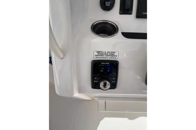 Slide: The Image of 2016 Regulator 34 Center Console dashboard with control panel and cup holder. - 22