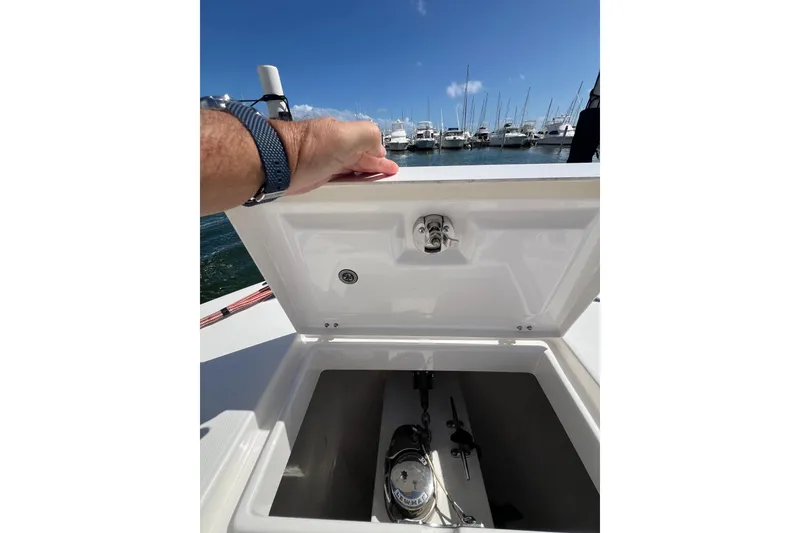 Slide: The Image of Open storage compartment on 2016 Regulator 34 Center Console boat, docked at marina. - 26